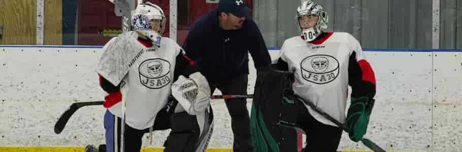 JS talking two 2 goalies during a camp